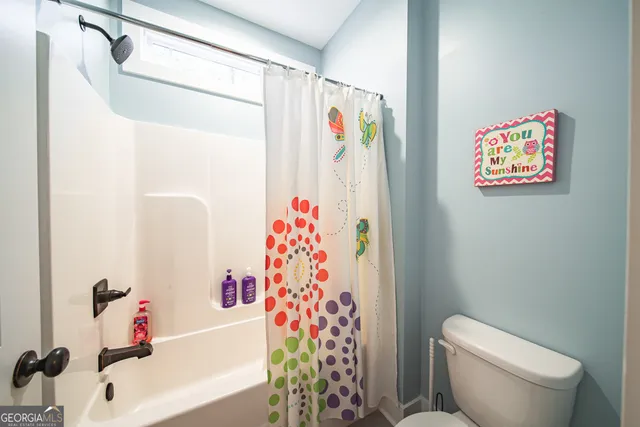 a living room with furniture and large windows