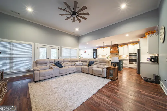 a living room with furniture a flat screen tv and a fireplace