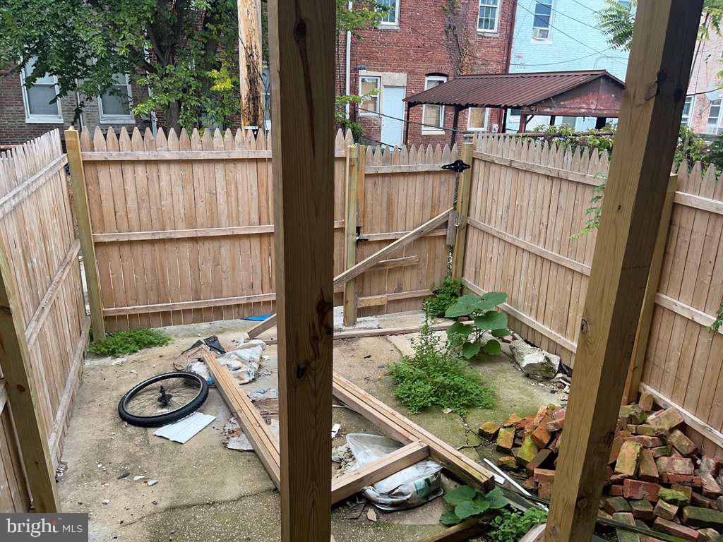 1726 Normal Avenue Baltimore, MD 21213 - Photo 16 of 18 a view of a balcony with door and wooden floor