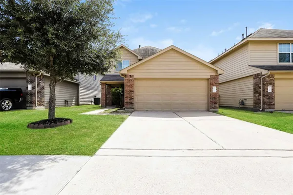 a front view of house with yard and garage