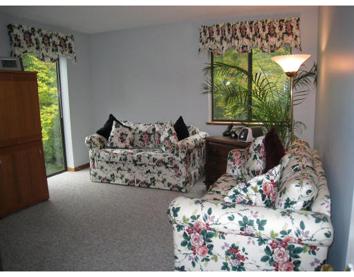179 Harper Ridge Road Hampstead, NH 03826 - Photo 14 of 26 a bed sitting in a bedroom next to a window