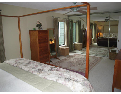179 Harper Ridge Road Hampstead, NH 03826 - Photo 17 of 26 a bedroom with a bed and a mirror