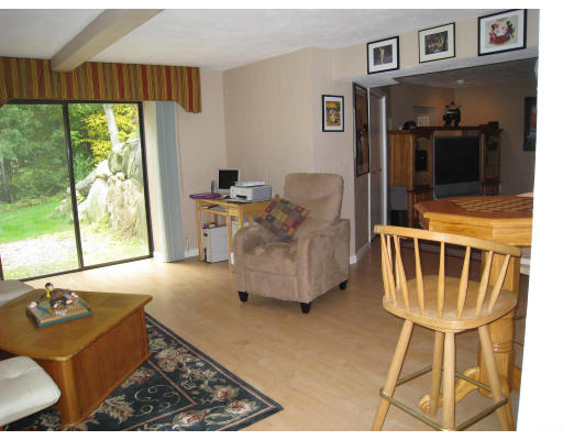 179 Harper Ridge Road Hampstead, NH 03826 - Photo 20 of 26 a living room with furniture and a floor to ceiling window