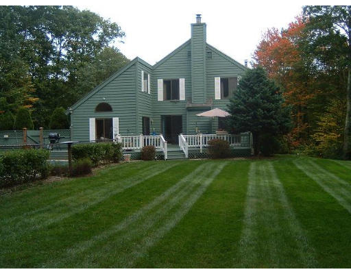 179 Harper Ridge Road Hampstead, NH 03826 - Photo 3 of 26 a front view of a house with a yard and trees