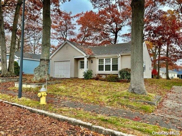 116 Sheffield Drive, Unit 116 Ridge, NY 11961 - Photo 1 of 1 a view of a house with a yard