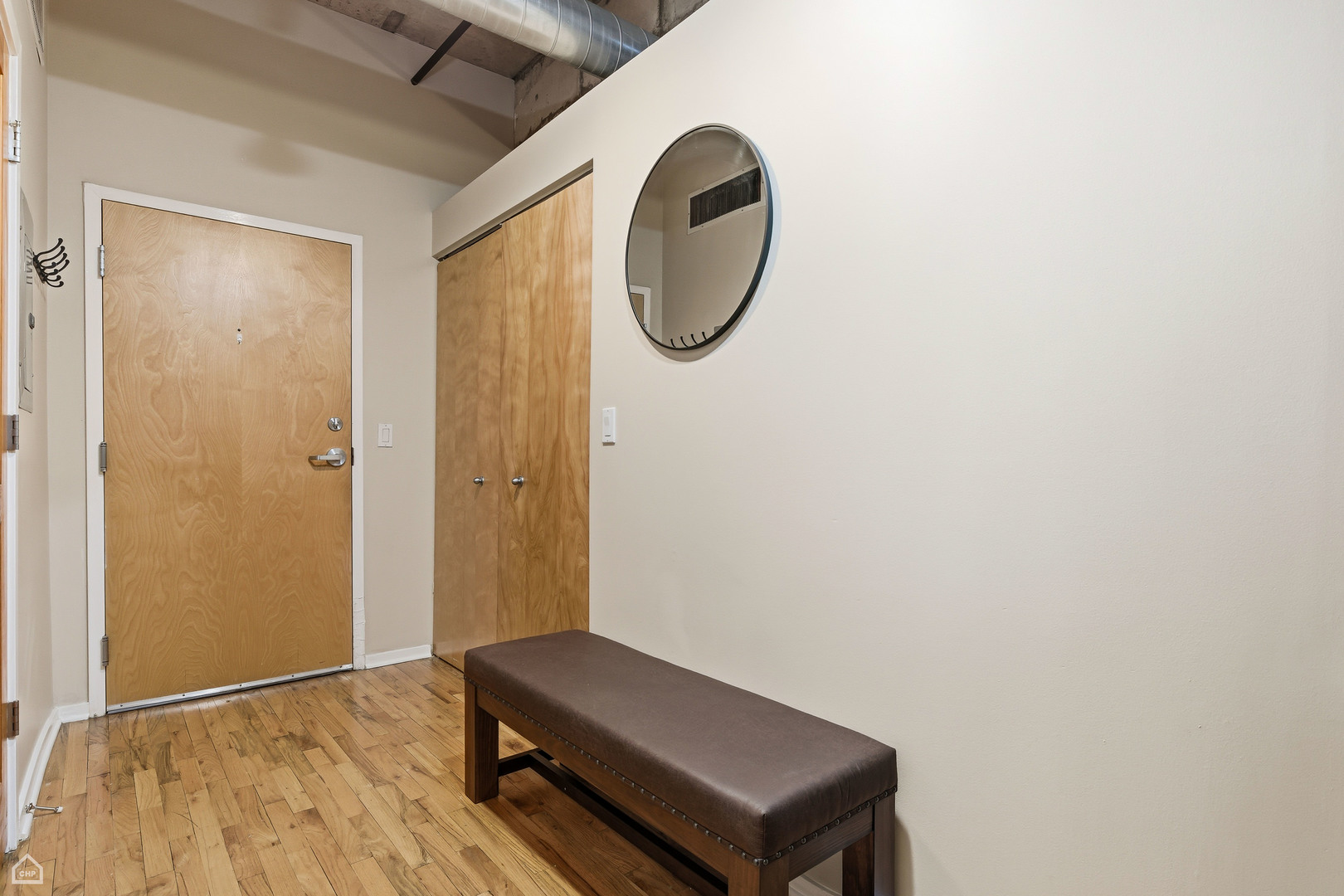6 South Laflin Street, Unit 920 Chicago, IL 60607 - Photo 2 of 17 a room with a bench and a mirror