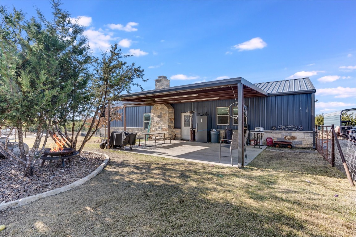 5450 County Road 202 Lampasas, TX 76550 - Photo 13 of 35 Rear view of property featuring an outdoor fire pit, a lawn, and a patio