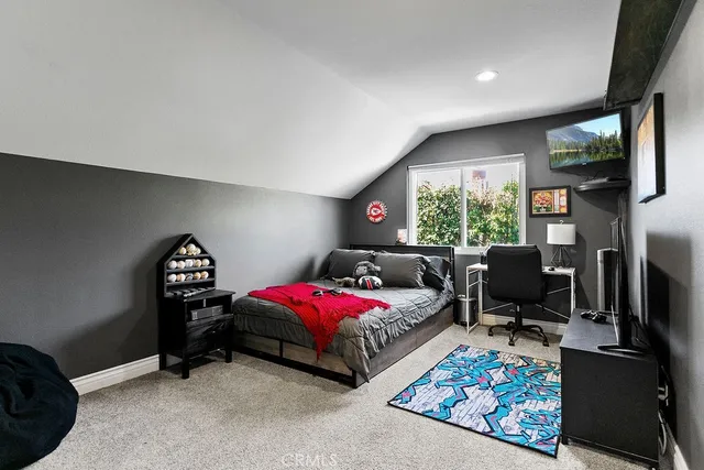 a bedroom with furniture and a window