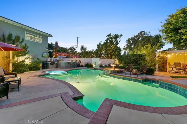 a view of a swimming pool with seating space