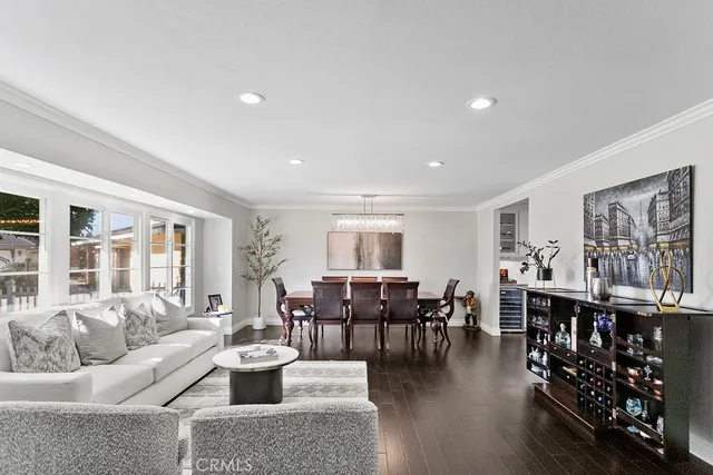 a living room with lots of furniture and wooden floor