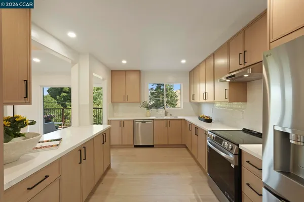 a large kitchen with stainless steel appliances kitchen island granite countertop a sink and cabinets