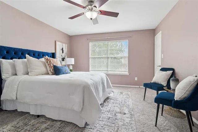 a bedroom with a bed and chair