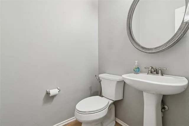 a bathroom with a sink a mirror and a toilet