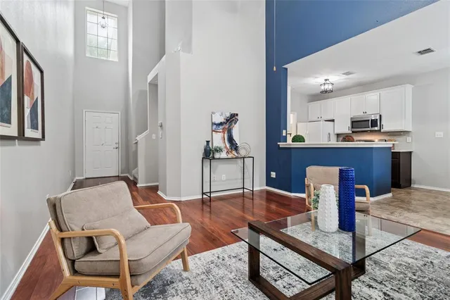 a living room with furniture and wooden floor