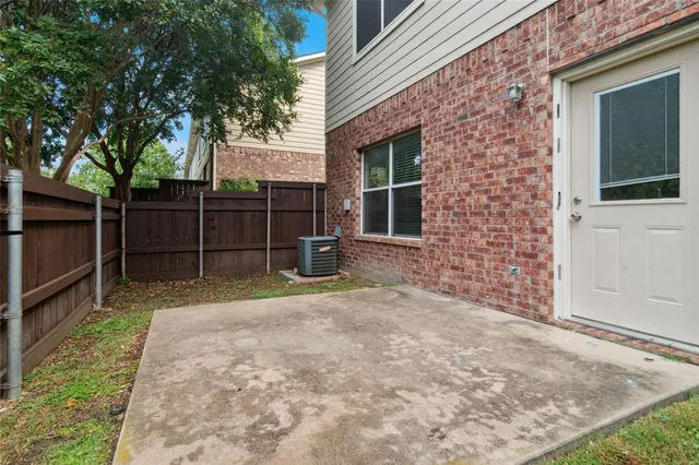 a view of backyard with wooden fence