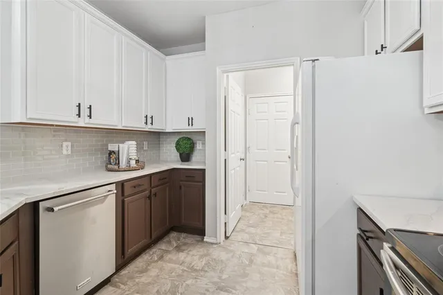 a kitchen with stainless steel appliances granite countertop a refrigerator and a stove