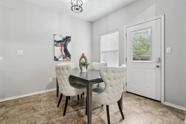 a view of a dining room with furniture and window