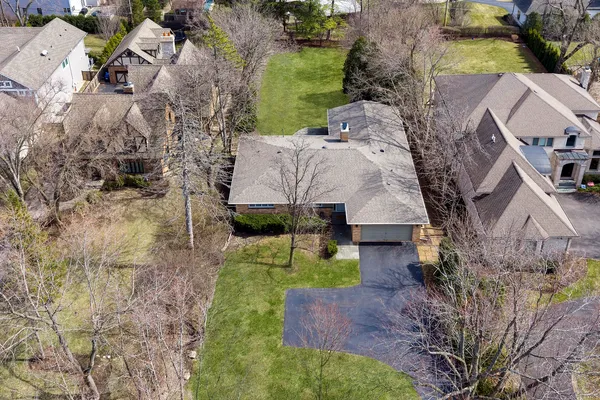 an aerial view of a house with a yard