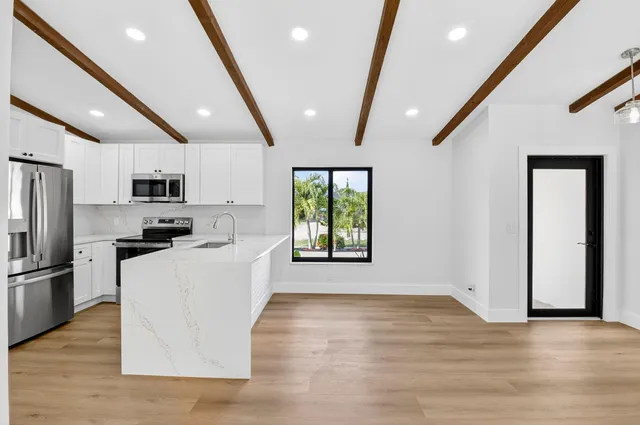 a kitchen with refrigerator and microwave