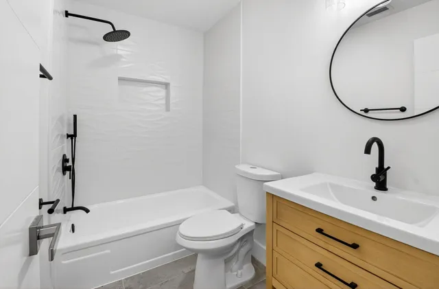 a bathroom with a sink a toilet and a mirror