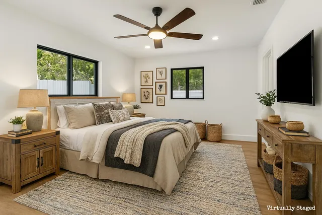 a bedroom with a large bed and a flat screen tv