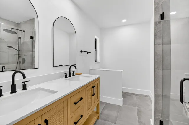a bathroom with a double vanity sink and a mirror