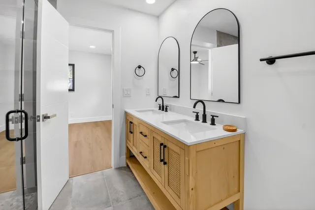 a bathroom with a double vanity sink and mirror
