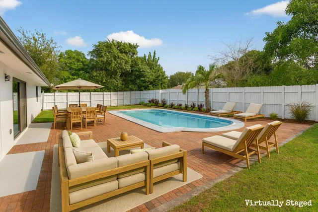 a view of a swimming pool with lounge chairs