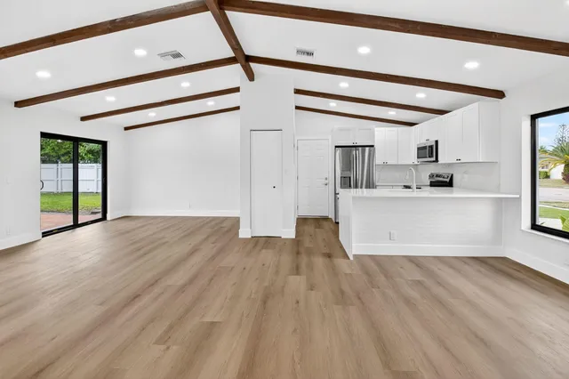 a view of a kitchen with a sink and cabinets
