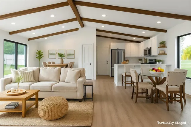 a living room with furniture kitchen and a table
