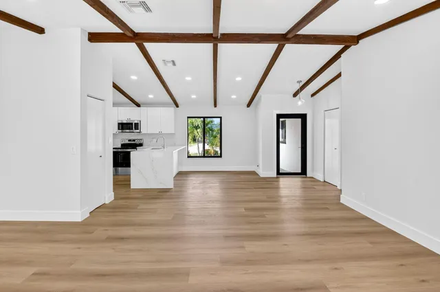 a view of an entryway with wooden floor