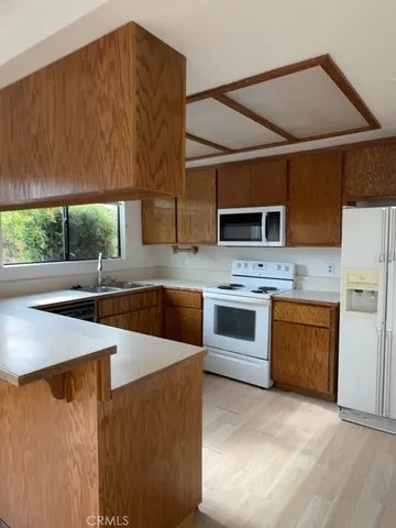 a kitchen with stainless steel appliances a stove sink and microwave