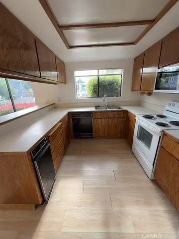 a kitchen with stainless steel appliances granite countertop a sink and stove top oven