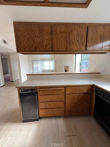 a kitchen with granite countertop a cabinets and window