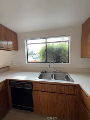 a kitchen with granite countertop a sink and a stove