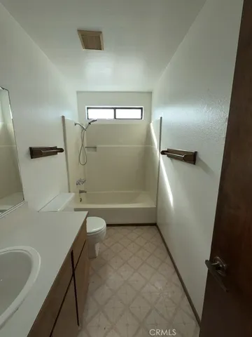 a bathroom with a bathtub sink and toilet
