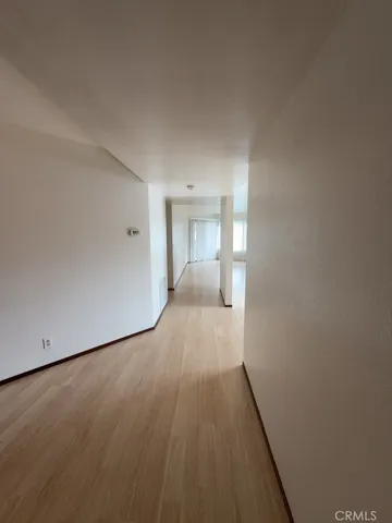 a view of a room with wooden floor