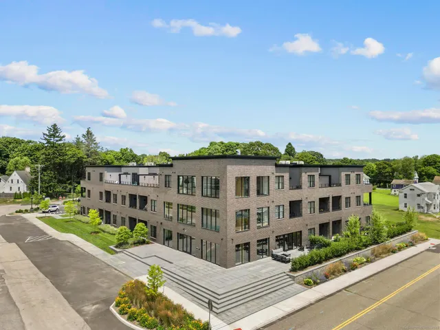 a view of a building with a garden and pathway