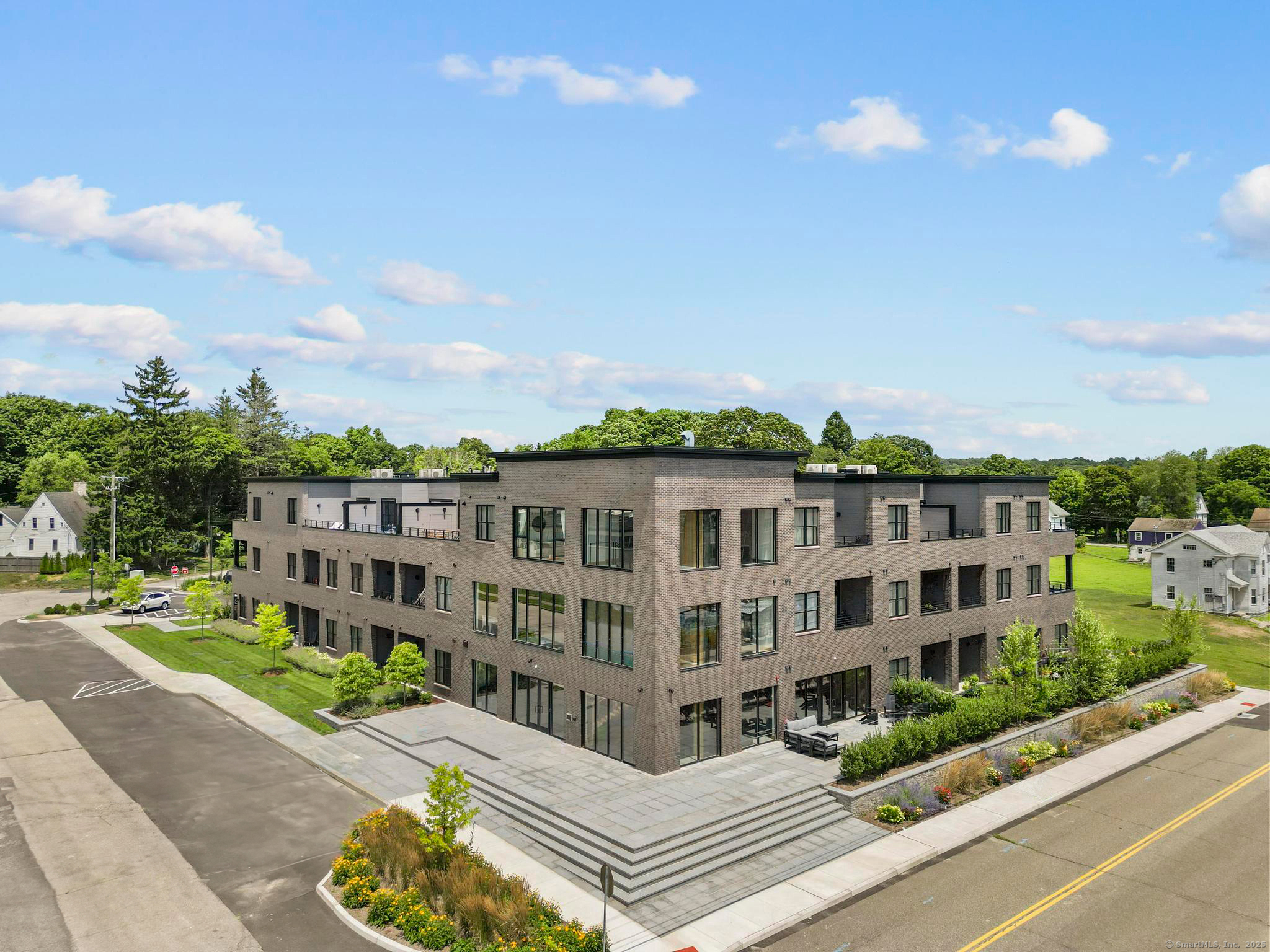 a view of a building with a garden and pathway
