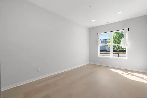 a bathroom with a toilet sink vanity and mirror