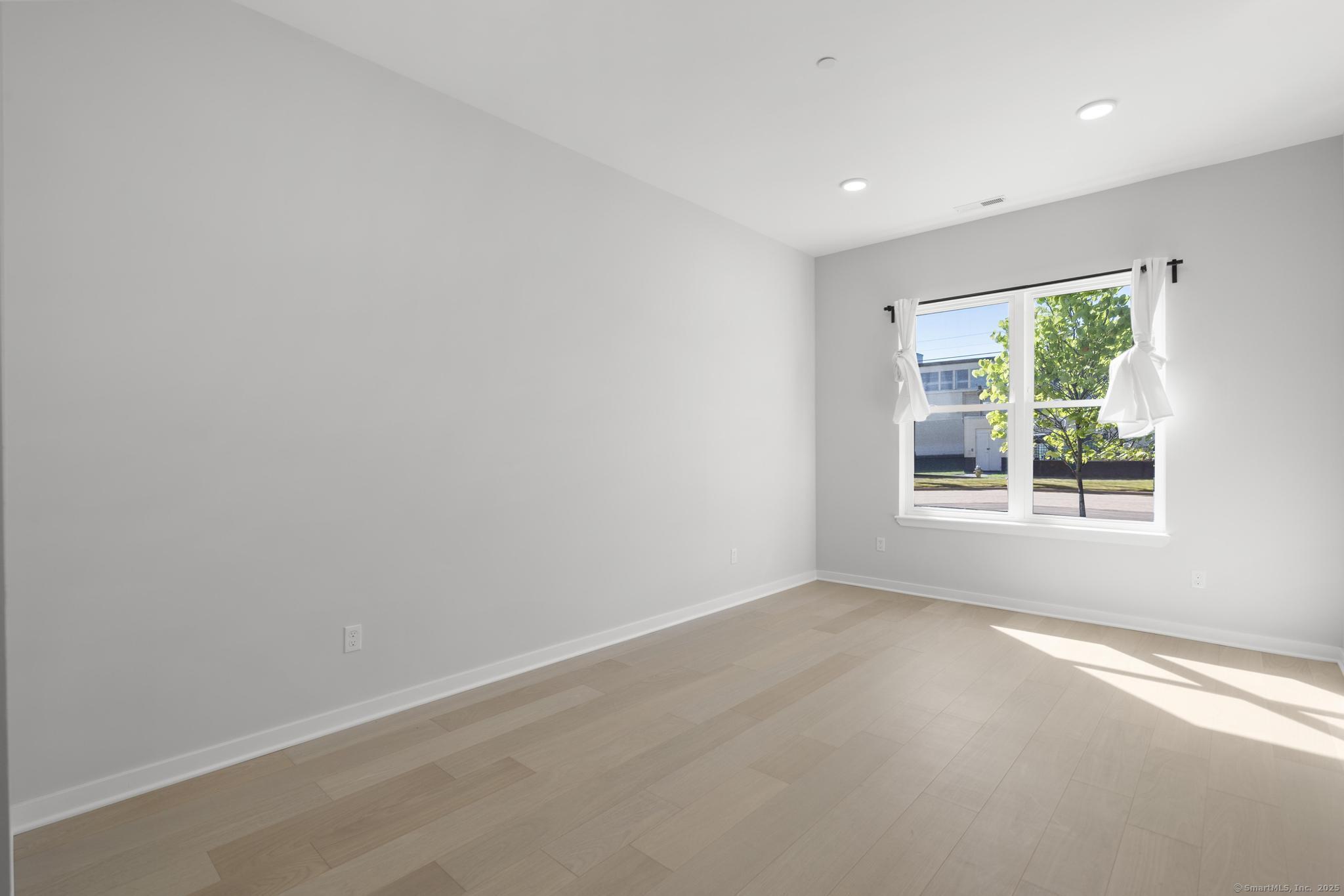 9 John Street Clinton, CT 06413 - Photo 13 of 18 an empty room with windows