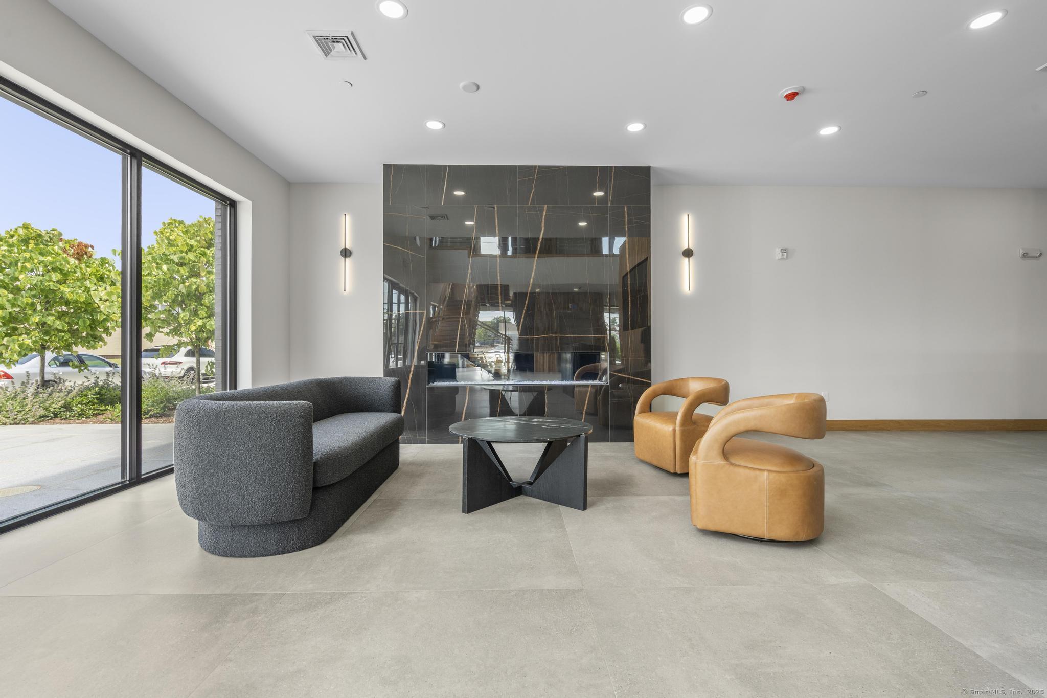 9 John Street Clinton, CT 06413 - Photo 2 of 18 a living room with couches and kitchen view