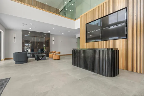 a lobby with furniture and a ceiling fan