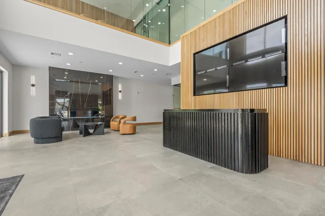 a lobby with furniture and a ceiling fan