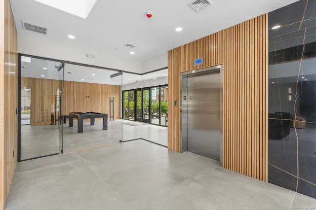 a lobby with furniture and floor to ceiling window