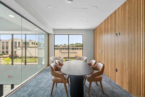 a view of a kitchen with table and chairs