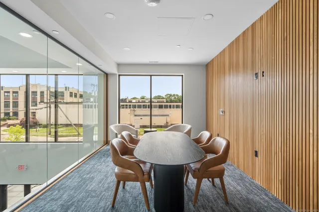 a view of a kitchen with table and chairs