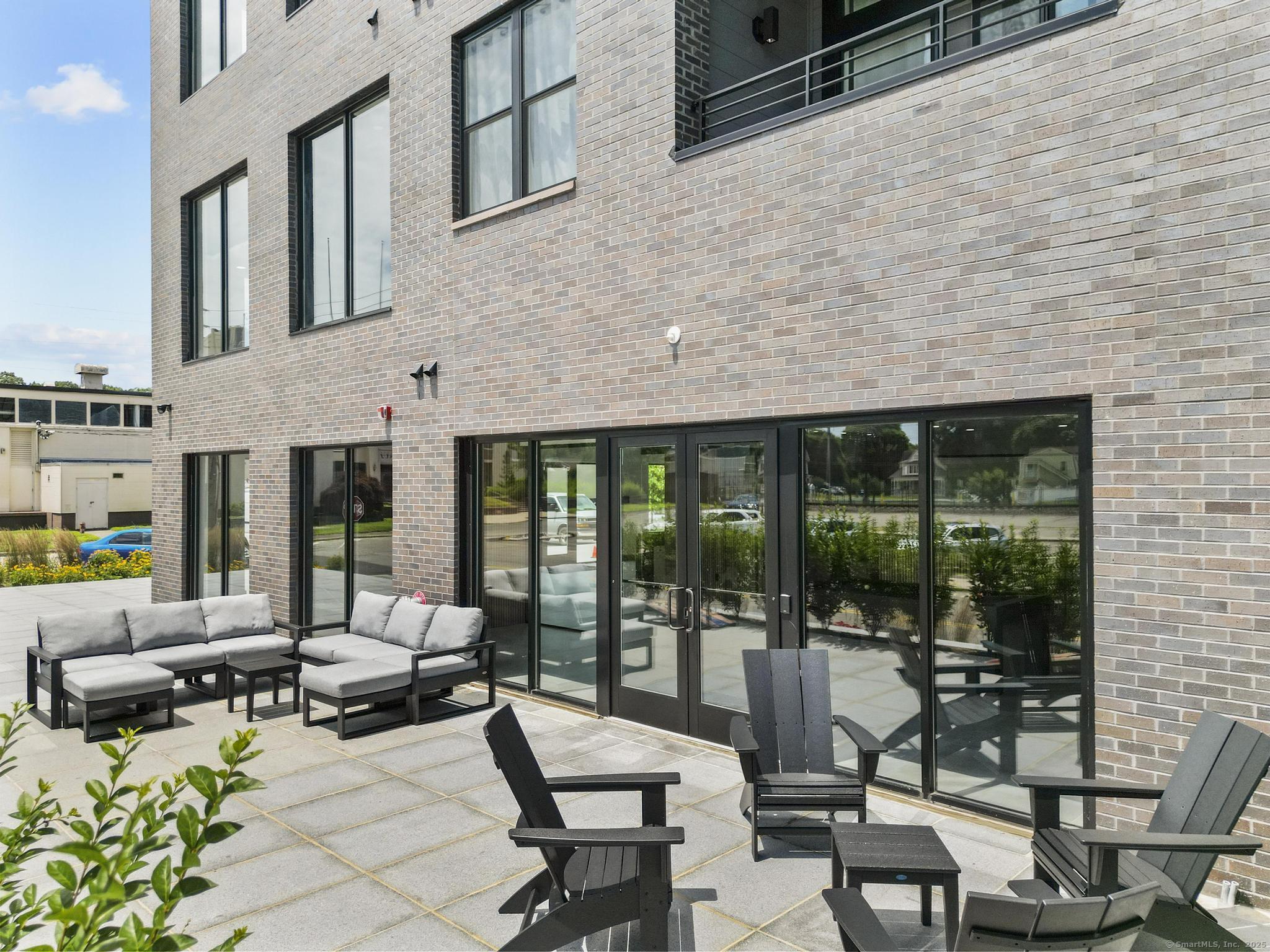 9 John Street Clinton, CT 06413 - Photo 9 of 18 a building outdoor space with patio furniture and potted plants