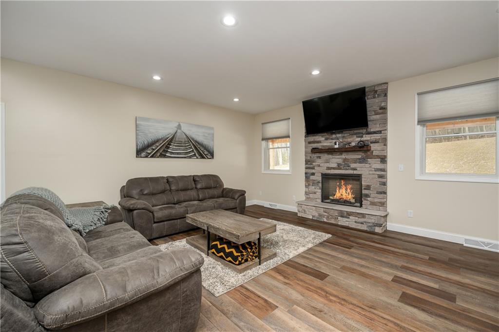117 Dodds Road Butler, PA 16002 - Photo 7 of 25 a living room with furniture a flat screen tv and a fireplace
