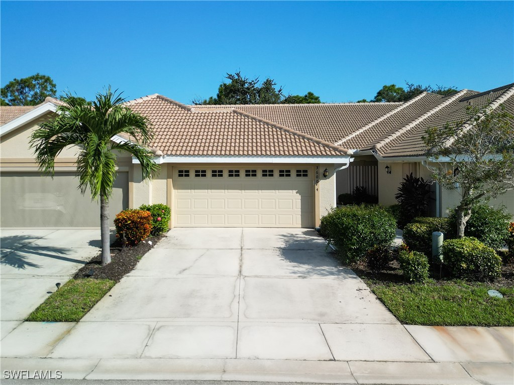 3600 Rue Alec Loop, Unit 4 North Fort Myers, FL 33917 - Photo 1 of 40 front view of a house with a yard and potted plants